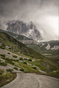 Scenic view of mountains against cloudy sky