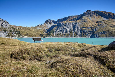 Scenic view of mountains against clear blue sky