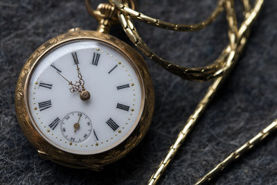 Close-up of pocket watch on table