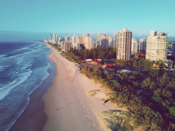 Panoramic view of beach and buildings against clear sky