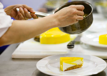 Cropped hands of person preparing food on table