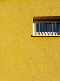 Low angle view of yellow wall