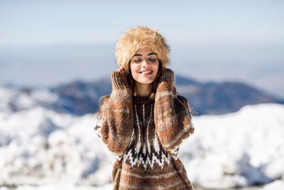 Young woman with eyes closed standing outdoors during winter