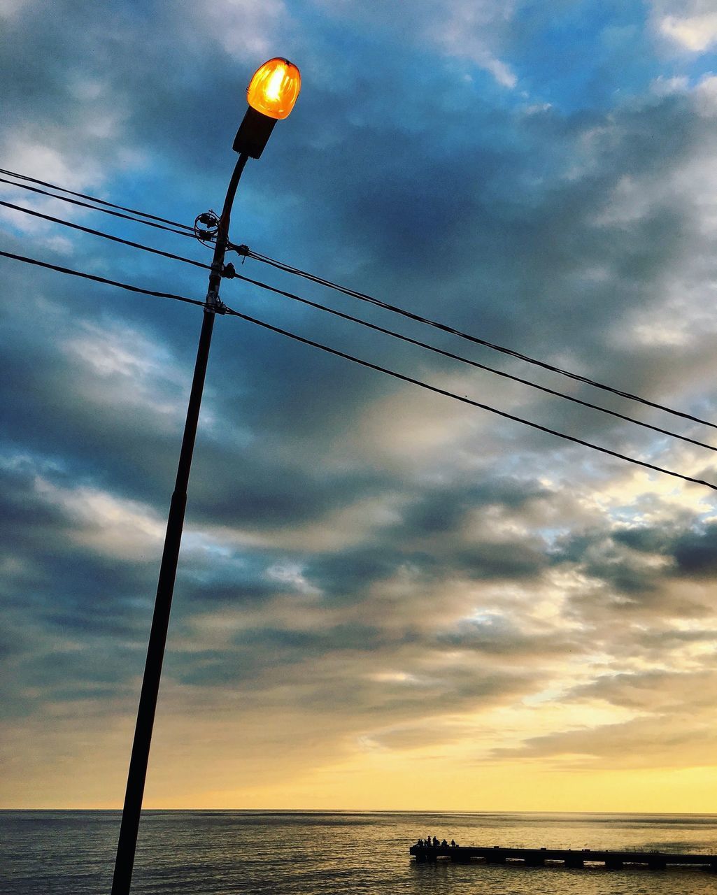 LOW ANGLE VIEW OF STREET LIGHTS AGAINST SKY