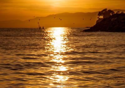 Scenic view of sea against orange sky