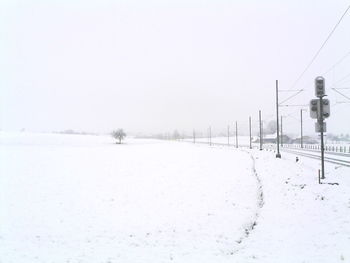 Snow covered landscape against clear sky
