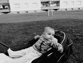 Cute baby boys on stroller at field