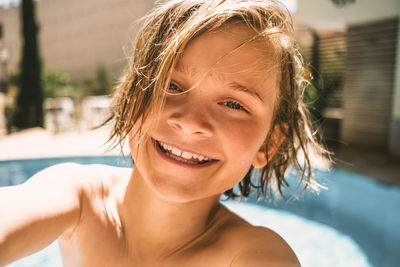 Portrait of smiling boy against resort swimming pool