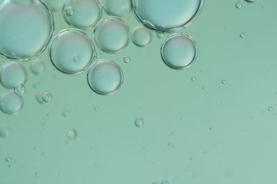 Top view oil bubbles drop on the water with colorful background, macro photography concept