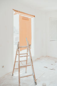 Ladder on white room at construction site. painting walls. home improvement, renovation