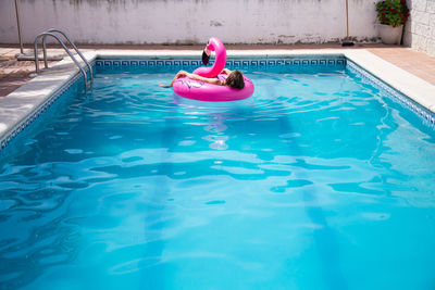 High angle view of boy swimming in pool