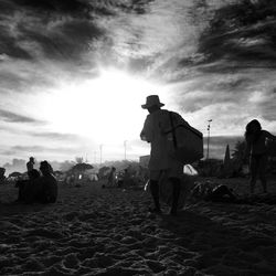 Silhouette of woman against cloudy sky