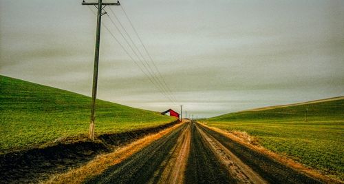 Road amidst landscape against sky