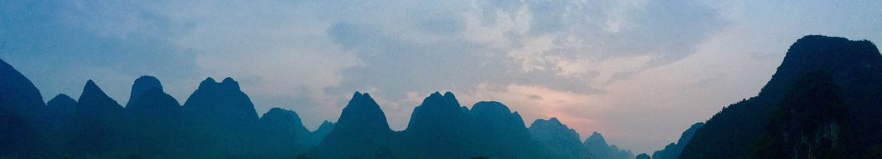 Panoramic view of silhouette mountains against sky
