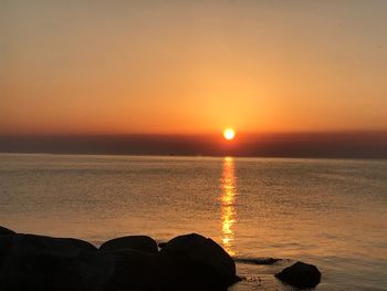 Scenic view of sea against romantic sky at sunset