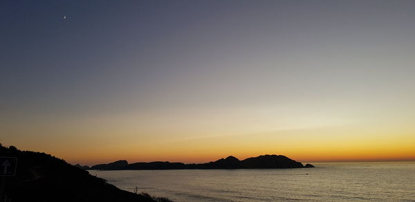 Scenic view of sea against clear sky during sunset