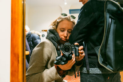 Full length of a man holding camera