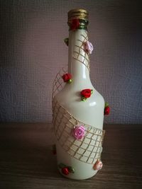 Close-up of figurine on table against wall