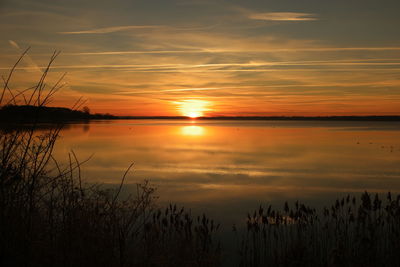 Scenic view of lake against sky during sunset