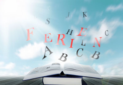 Low angle view of information sign against sky