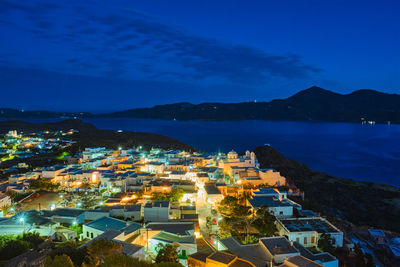 High angle view of townscape by sea against sky