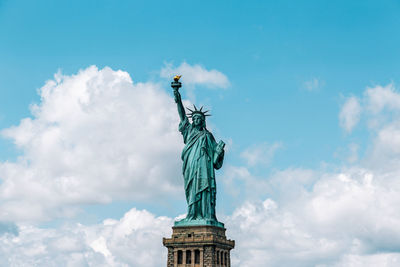 Low angle view of statue against cloudy sky