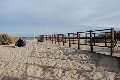 Father and daughter with dog at beach