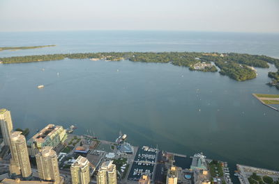 High angle view of buildings by sea against sky