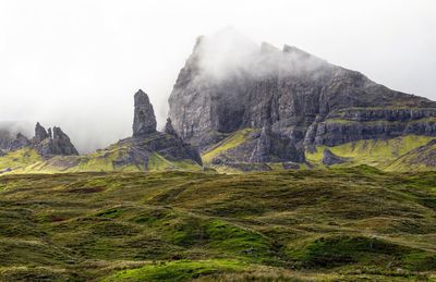 Scenic view of mountains against cloudy sky