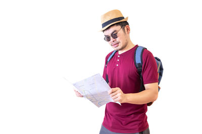 Young man wearing hat standing against white background