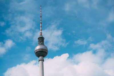 Low angle view of television tower - berlin against cloudy sky