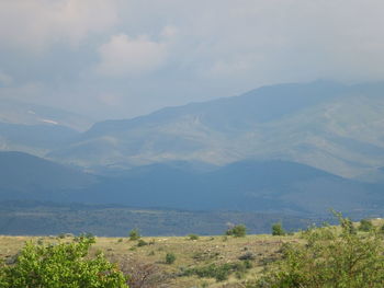 Scenic view of landscape and mountains against sky