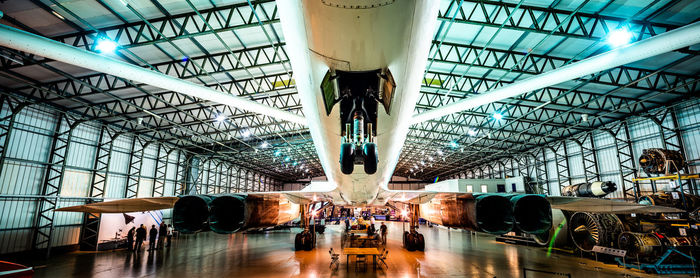 Reflection of people on airplane at airport