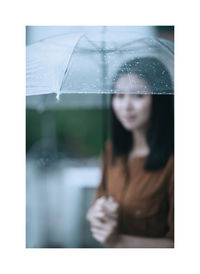Portrait of woman standing by window