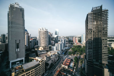 Aerial view of modern buildings in city against sky