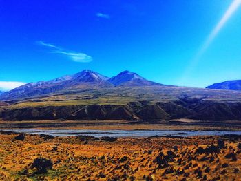 View of mountain range against blue sky