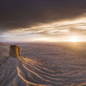 Erosion cuts deep lines in the earth surround the chimney rock m