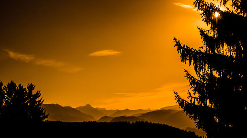 Scenic view of silhouette mountains against sky during sunset