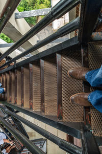 Low section of man standing on staircase