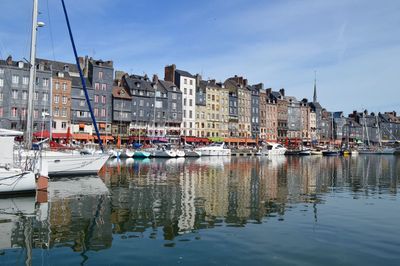 Boats in harbor with buildings in background