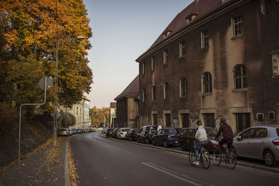 Cars on road amidst buildings in city