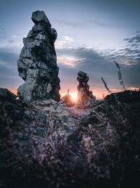 Low angle view of rock formation against sky during sunset