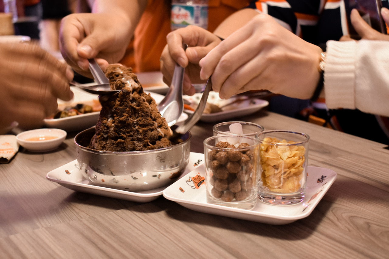 food and drink, food, table, real people, plate, hand, freshness, human hand, indoors, ready-to-eat, people, midsection, human body part, holding, focus on foreground, eating utensil, close-up, serving size, kitchen utensil, temptation, tray