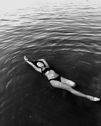 High angle view of young woman swimming in sea