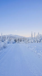 Scenic view of snowcapped landscape against clear blue sky