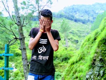 Full length of man standing against wall