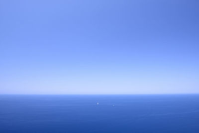 Scenic view of sea against clear blue sky