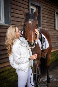 Side view of woman riding horse