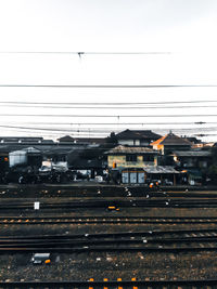 Railroad tracks in city against sky