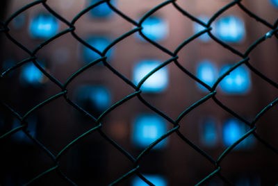 Full frame shot of chainlink fence against building